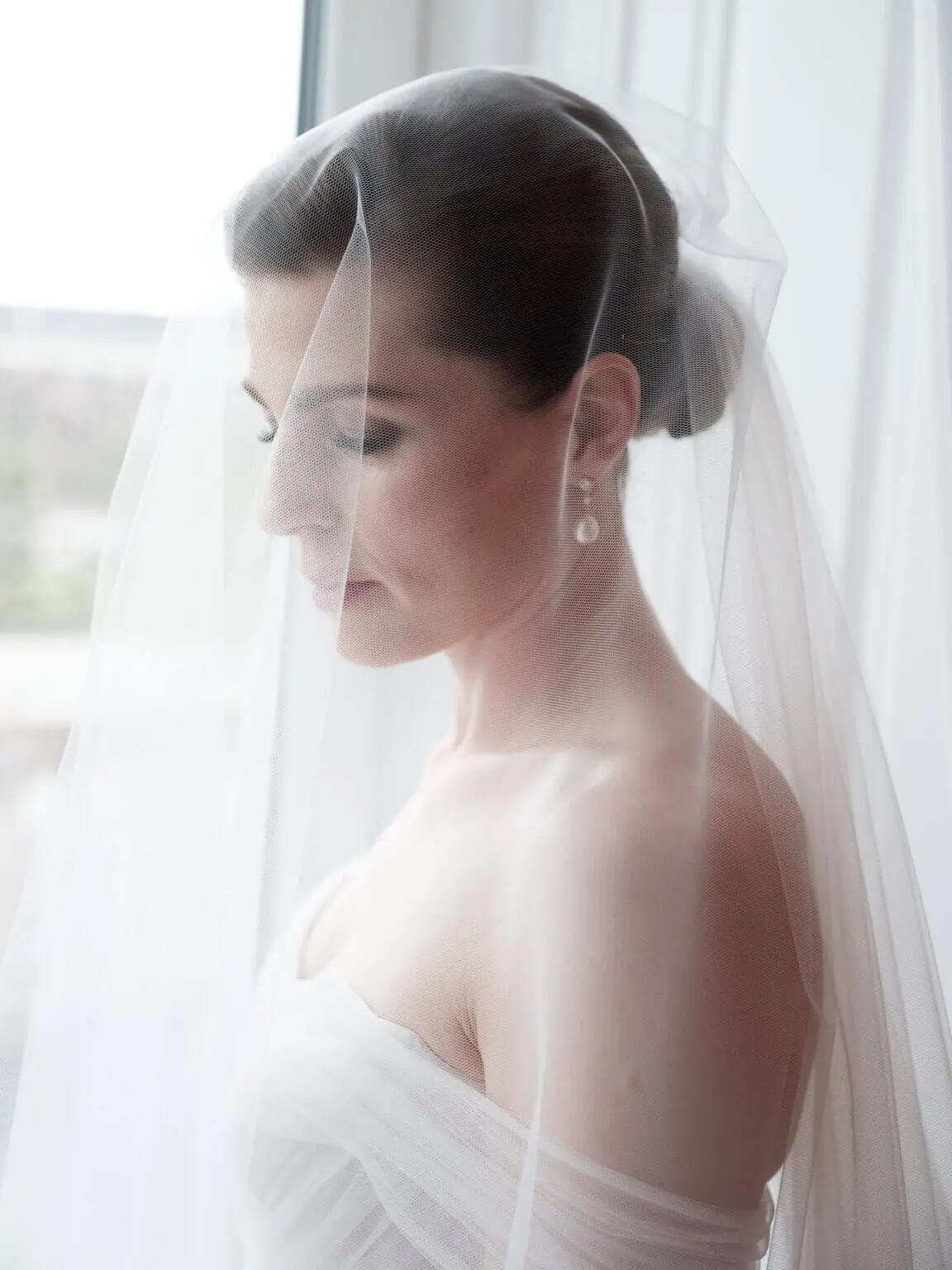 Modern editorial bridal portrait with a veil