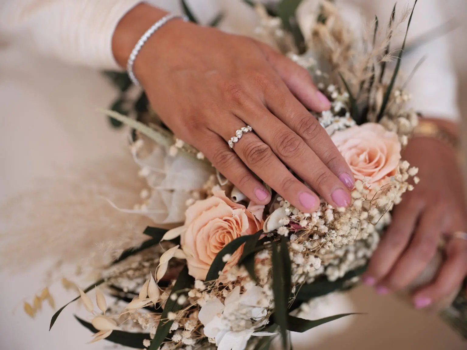 Bride's hands gracefully holding her bouquet near the Riding Grounds at Christiansborg Palace.