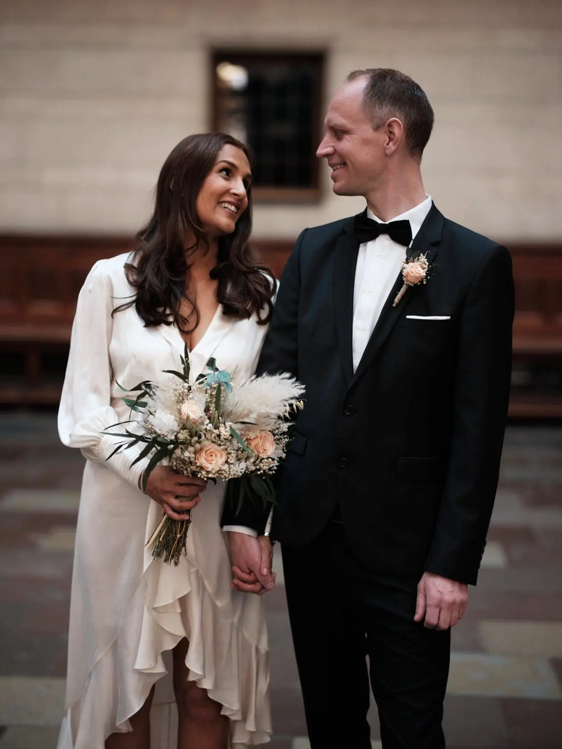 Bride and groom sharing a joyful moment at Copenhagen City Hall, captured by a skilled wedding photographer.