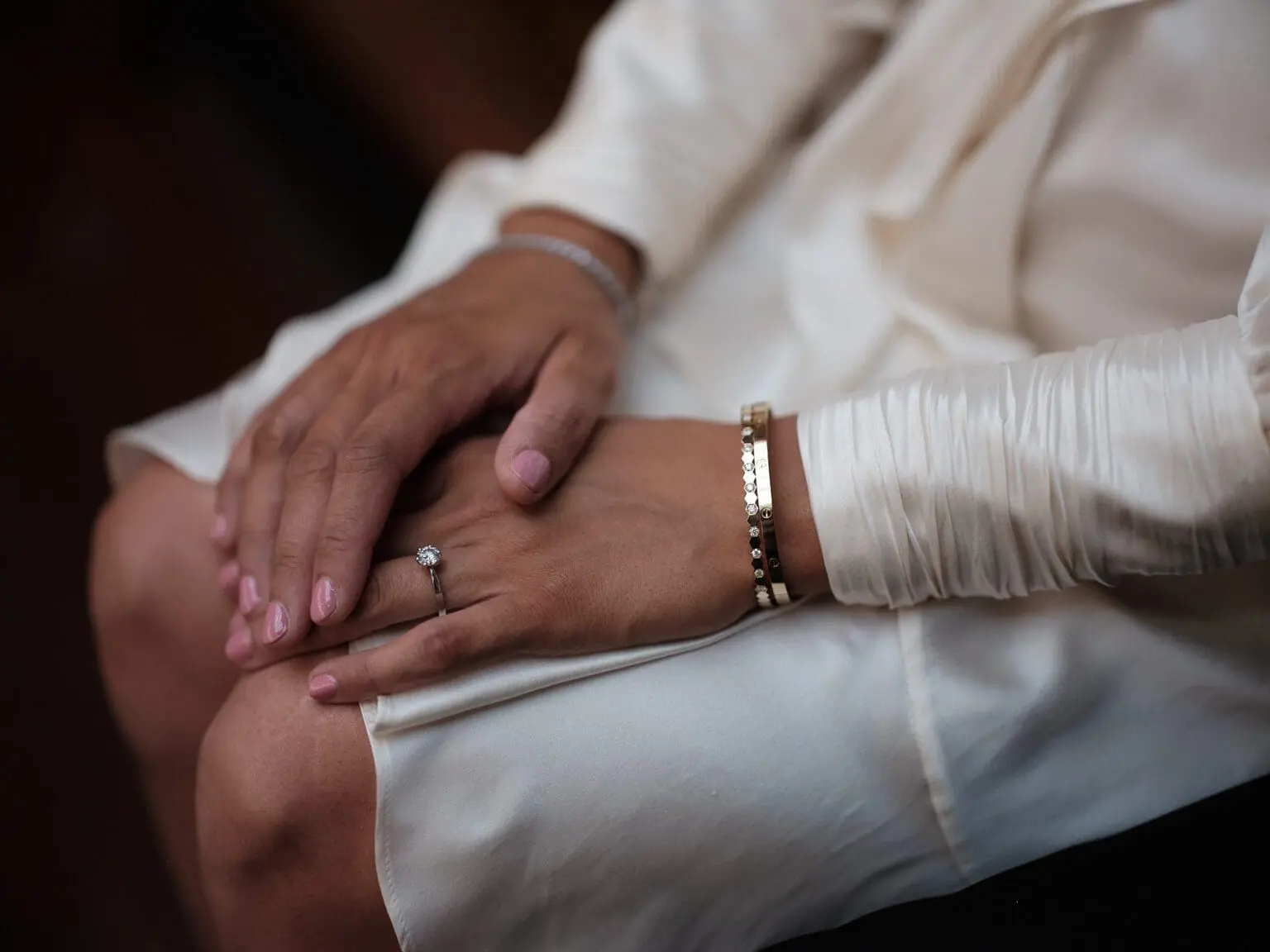 Close-up of a newlywed couple's hands at Copenhagen City Hall, with the bride's ring in focus.