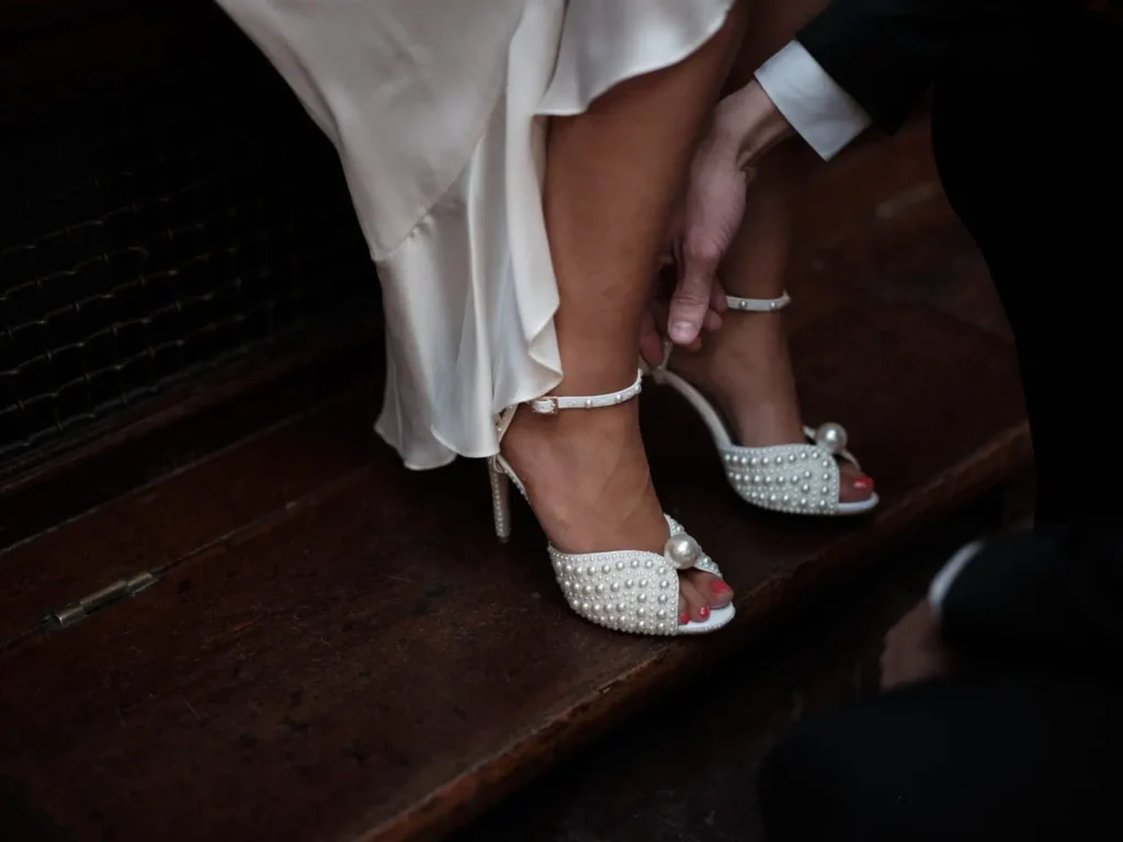 Bride's pearl-embellished heels at Copenhagen City Hall captured by a wedding photographer.