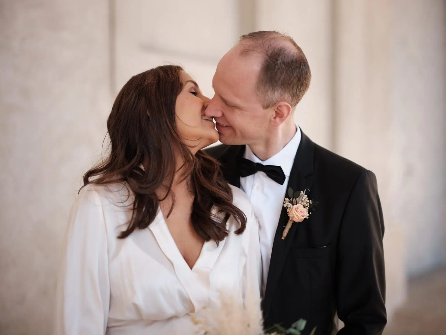 Bride and groom sharing a candid kiss at the Riding Ground Complex near Christiansborg Palace.